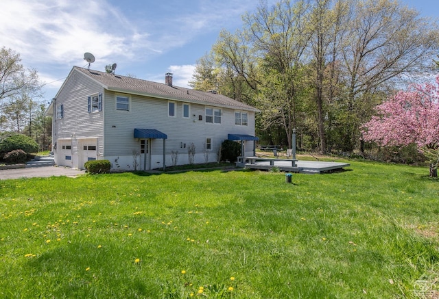 1536 State Route 213, Marbletown, NY 12440 - rear view of house featuring a chimney, an attached garage, a lawn, and asphalt driveway