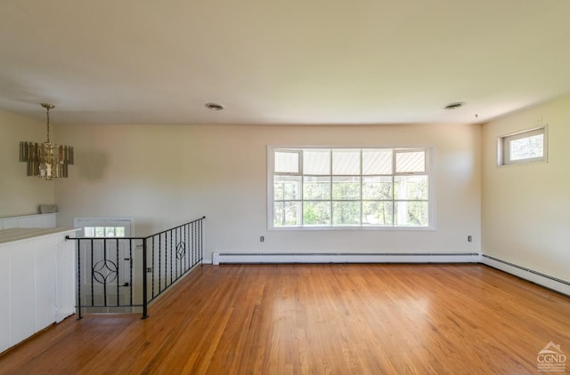 1536 State Route 213, Marbletown, NY 12440 - empty room featuring a chandelier, wood finished floors, and a baseboard radiator