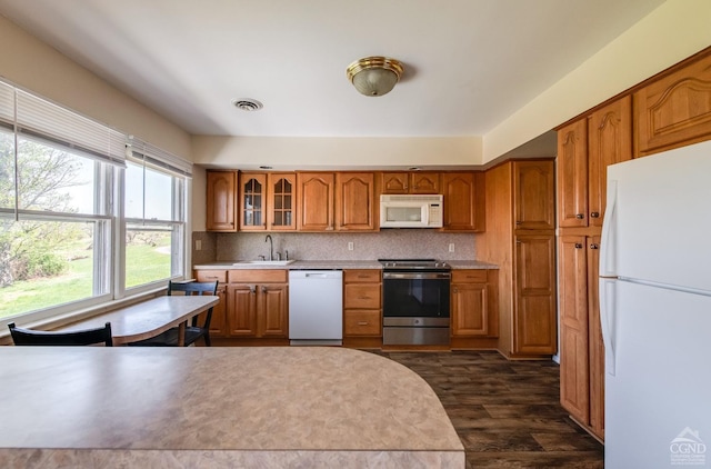 1536 State Route 213, Marbletown, NY 12440 - kitchen featuring white appliances, brown cabinetry, light countertops, glass insert cabinets, and dark wood-style flooring