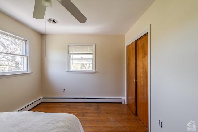 1536 State Route 213, Marbletown, NY 12440 - bedroom with multiple windows, wood finished floors, a closet, and ceiling fan