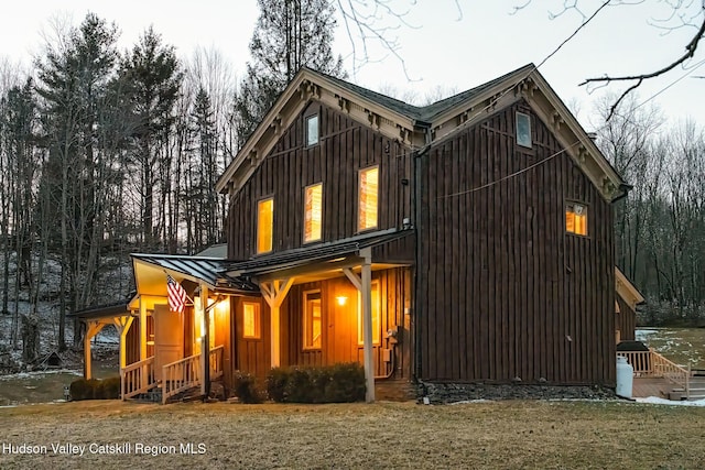 view of front of house with a standing seam roof, board and batten siding, and metal roof