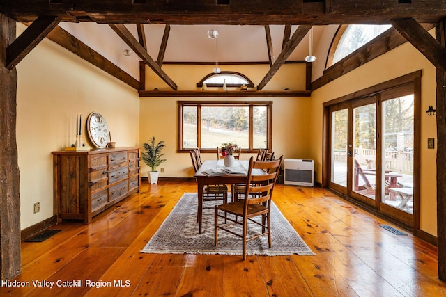 dining area featuring heating unit, visible vents, plenty of natural light, and wood-type flooring