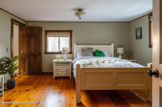 bedroom featuring crown molding and hardwood / wood-style floors