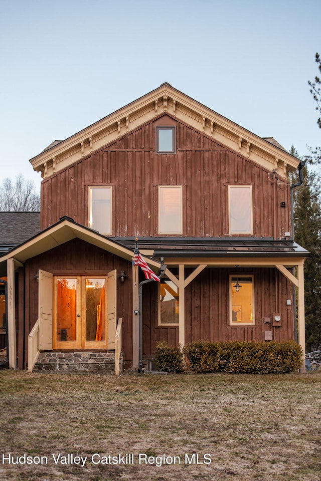 view of front of house featuring board and batten siding and roof with shingles