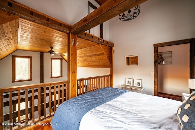 bedroom with vaulted ceiling and wood ceiling