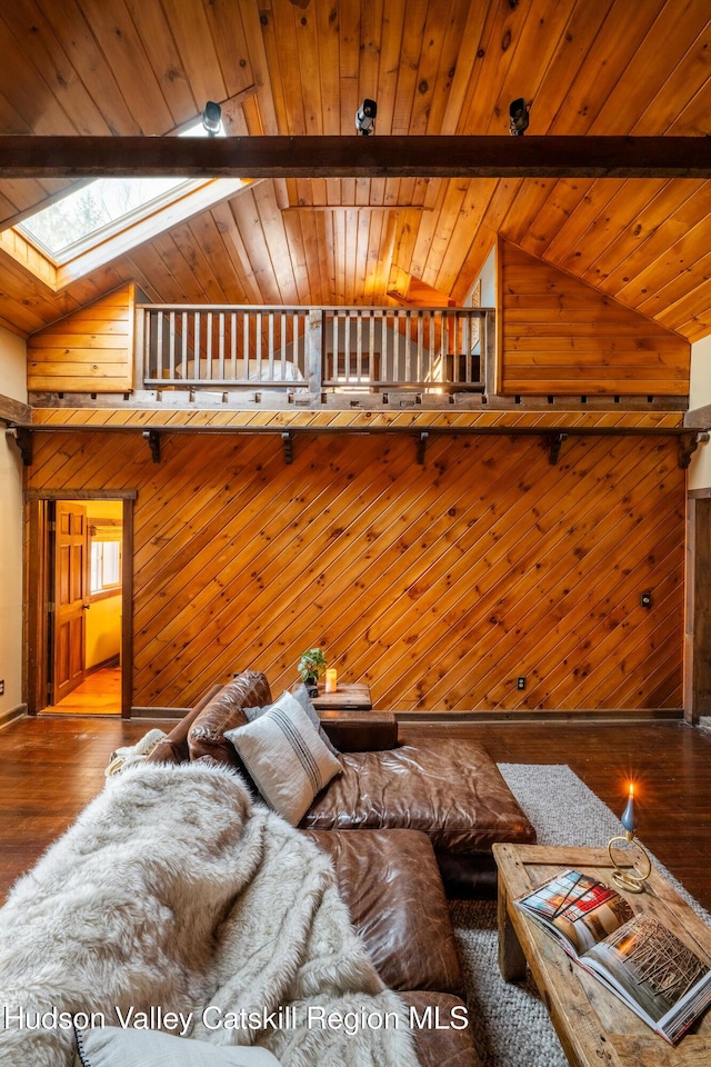 unfurnished living room with lofted ceiling with skylight, wooden walls, wooden ceiling, and wood finished floors