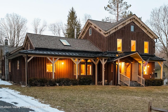 view of front of home featuring board and batten siding, metal roof, a standing seam roof, and roof with shingles