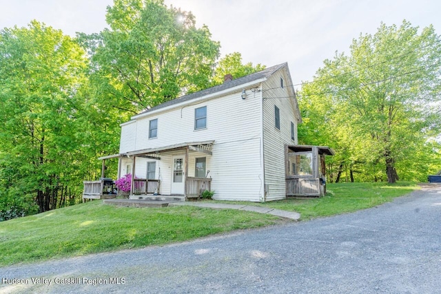 420 Crescent Ave, Highland, NY 12528 - view of front of house featuring covered porch, a front lawn, and a chimney