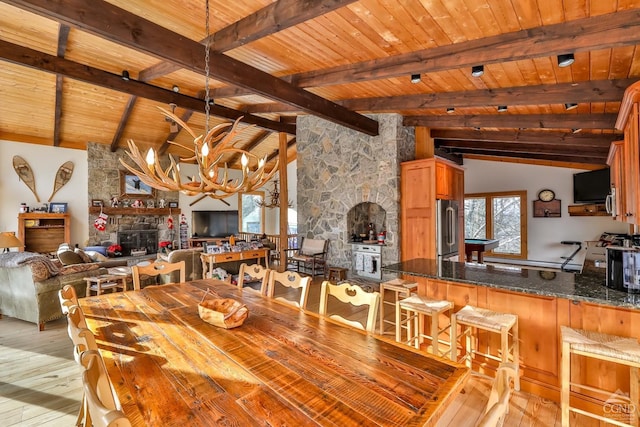 90 Club Rd, Windham, NY 12496 - dining space with wood ceiling, light wood-style floors, a chandelier, and a fireplace