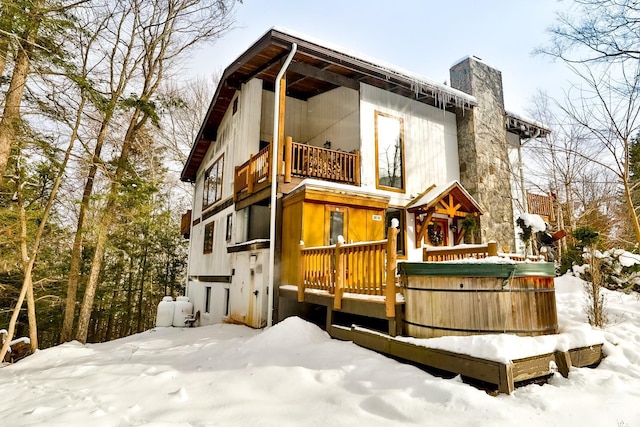 90 Club Rd, Windham, NY 12496 - snow covered house with a hot tub, a chimney, and a balcony