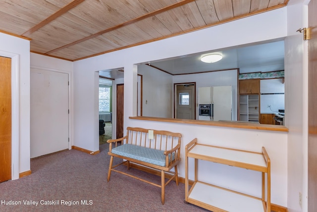 kitchen featuring white refrigerator with ice dispenser, wooden ceiling, crown molding, and carpet flooring