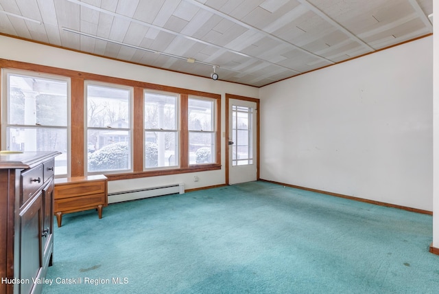 unfurnished room featuring a healthy amount of sunlight, light carpet, and a baseboard heating unit