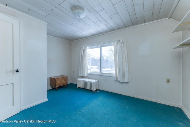 interior space featuring wooden ceiling, ornamental molding, radiator heating unit, and dark colored carpet