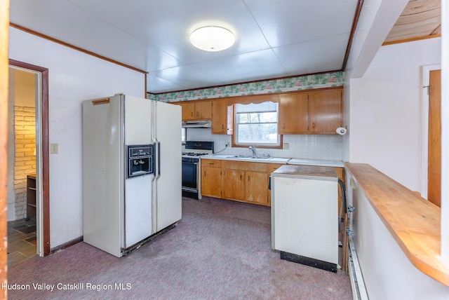 kitchen with white appliances, butcher block countertops, tasteful backsplash, and sink