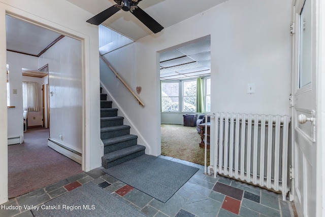 interior space with ceiling fan, radiator heating unit, baseboard heating, and carpet