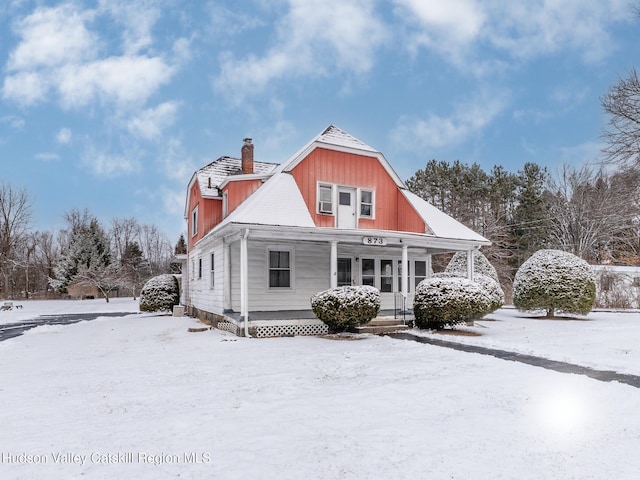 view of snow covered rear of property