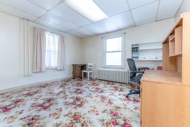 home office with a paneled ceiling and radiator