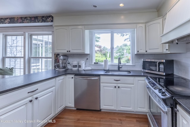157 Hillside Ter, Kingston, NY 12401 - kitchen with stainless steel appliances, custom exhaust hood, dark countertops, backsplash, and ornamental molding