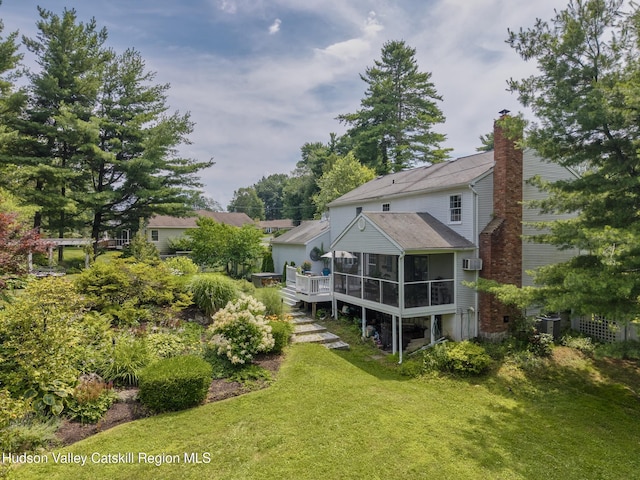 157 Hillside Ter, Kingston, NY 12401 - back of house featuring a sunroom, a chimney, and a yard