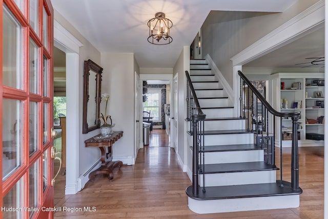 157 Hillside Ter, Kingston, NY 12401 - entrance foyer featuring wood finished floors, stairway, a chandelier, and a baseboard radiator