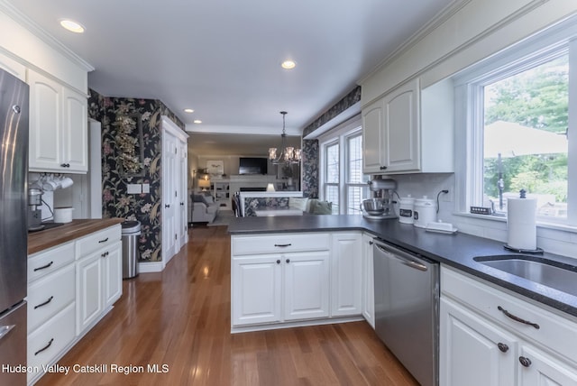 157 Hillside Ter, Kingston, NY 12401 - kitchen with stainless steel appliances, a peninsula, a chandelier, white cabinets, and recessed lighting