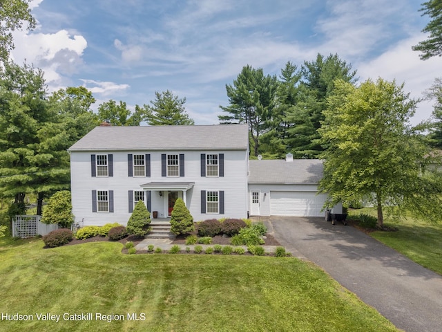 157 Hillside Ter, Kingston, NY 12401 - colonial-style house with asphalt driveway, a front yard, a chimney, and an attached garage
