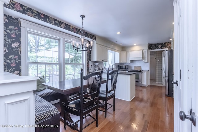 157 Hillside Ter, Kingston, NY 12401 - dining room with a chandelier, wood finished floors, and wallpapered walls