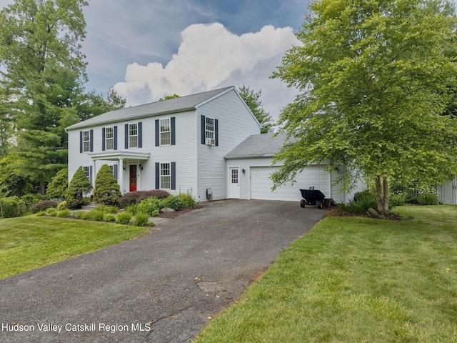 157 Hillside Ter, Kingston, NY 12401 - colonial-style house featuring an attached garage, asphalt driveway, a front yard, and roof with shingles