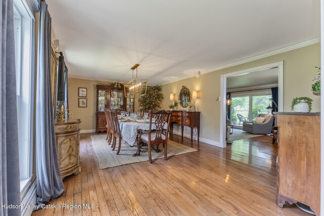 157 Hillside Ter, Kingston, NY 12401 - dining room with light wood-style flooring, crown molding, and a chandelier