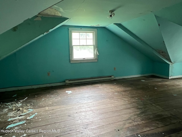 additional living space with baseboard heating, wood-type flooring, and vaulted ceiling