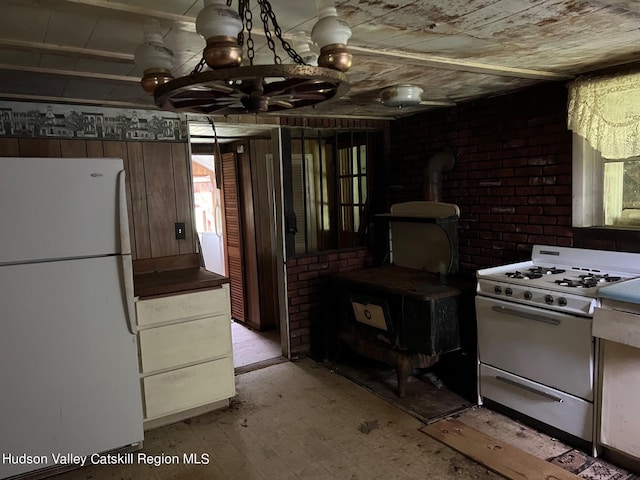 kitchen featuring white appliances and a notable chandelier