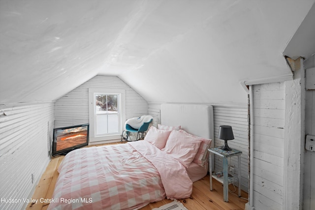 bedroom with light hardwood / wood-style floors and vaulted ceiling