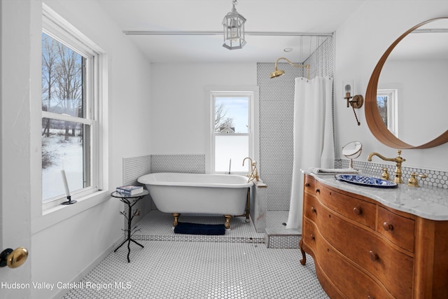 bathroom featuring tile patterned floors, vanity, plus walk in shower, and tile walls