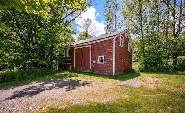 view of outbuilding featuring a lawn