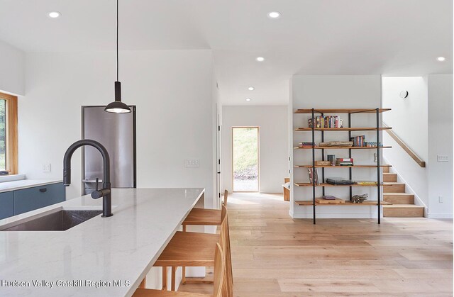 99 Cannon Cir, Woodstock, NY 12498 - kitchen featuring a sink, plenty of natural light, light wood-style floors, recessed lighting, and light stone countertops