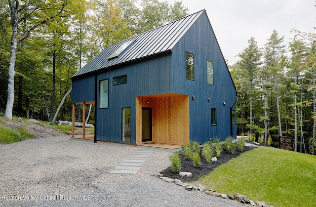 99 Cannon Cir, Woodstock, NY 12498 - view of front of property with a standing seam roof, metal roof, a front yard, and a garage