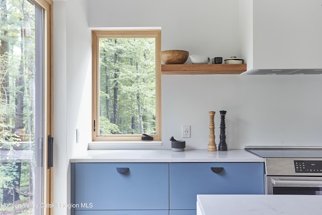99 Cannon Cir, Woodstock, NY 12498 - kitchen view of open shelves, light countertops, and stove