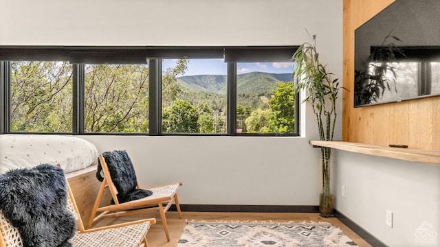 7717 Main St, Hunter, NY 12442 - sitting room with a mountain view, baseboards, and wood finished floors