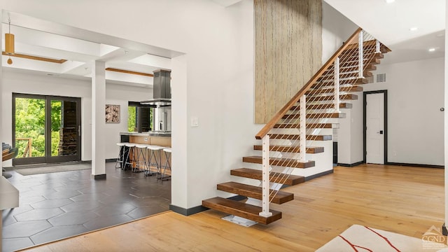 7717 Main St, Hunter, NY 12442 - staircase featuring a high ceiling, baseboards, wood finished floors, and recessed lighting