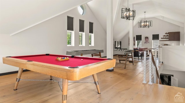 7717 Main St, Hunter, NY 12442 - recreation room with lofted ceiling, light wood finished floors, billiards, and a chandelier