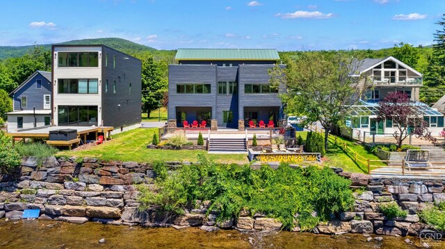 7717 Main St, Hunter, NY 12442 - rear view of house featuring a balcony and metal roof