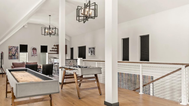 7717 Main St, Hunter, NY 12442 - playroom featuring a chandelier, high vaulted ceiling, and wood finished floors