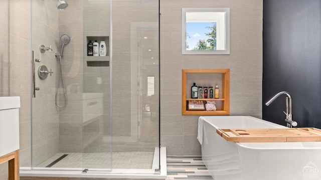 7717 Main St, Hunter, NY 12442 - bathroom featuring a shower stall and a freestanding tub