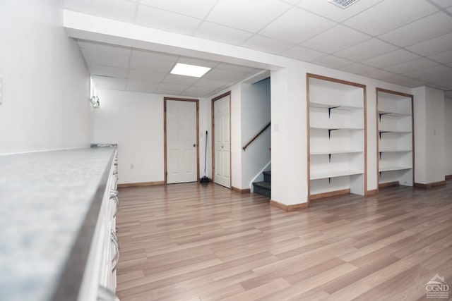 147 Skyview, Greenville, NY 12083 - finished basement featuring a drop ceiling, stairs, built in shelves, light wood-type flooring, and baseboards