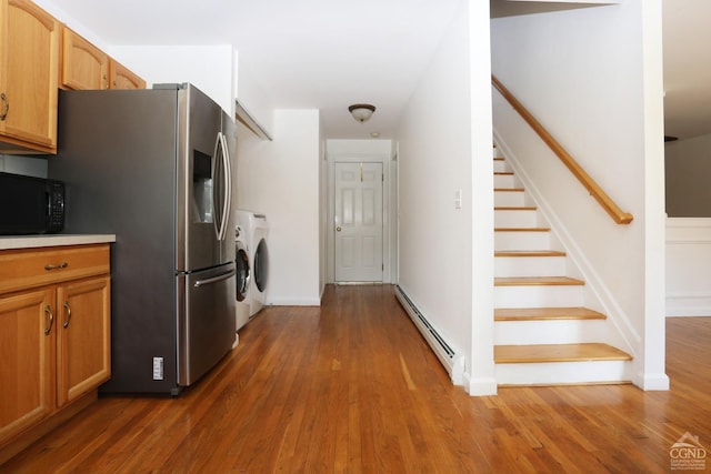 147 Skyview, Greenville, NY 12083 - kitchen with a baseboard heating unit, black microwave, washing machine and dryer, and wood finished floors