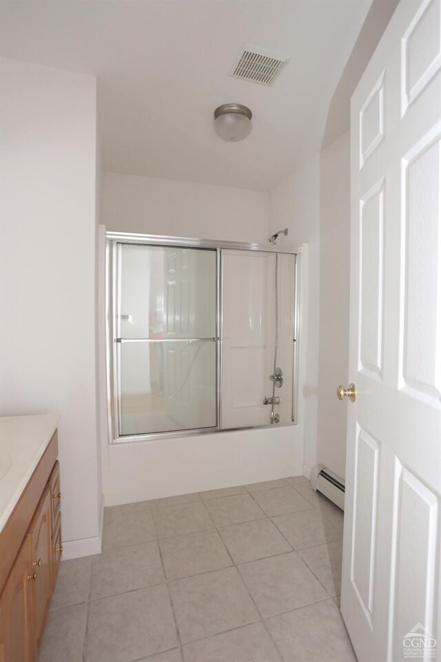 147 Skyview, Greenville, NY 12083 - full bathroom with a baseboard radiator, bath / shower combo with glass door, vanity, and tile patterned flooring