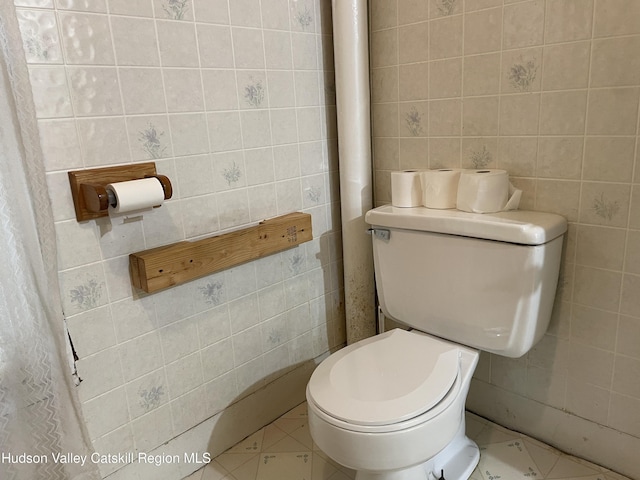 63 Gill St, Kingston, NY 12401 - bathroom featuring tile walls, toilet, and tile patterned flooring
