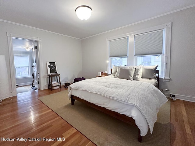 bedroom featuring hardwood / wood-style flooring and ornamental molding