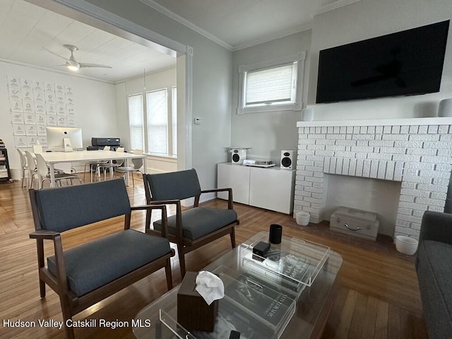 living room with wood-type flooring, ceiling fan, and crown molding