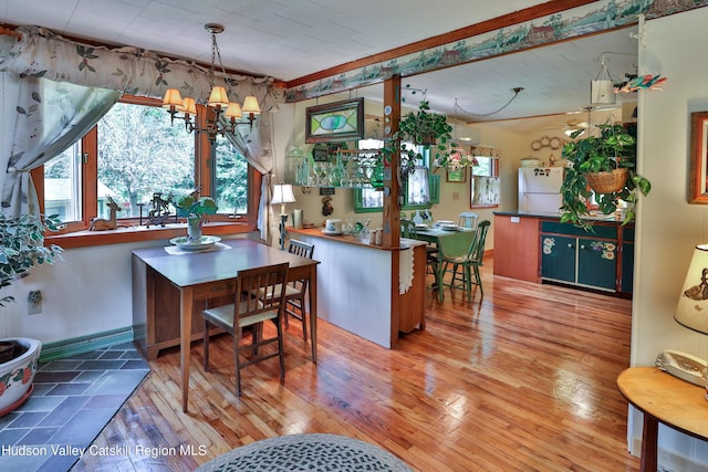 dining area featuring hardwood / wood-style floors and a notable chandelier